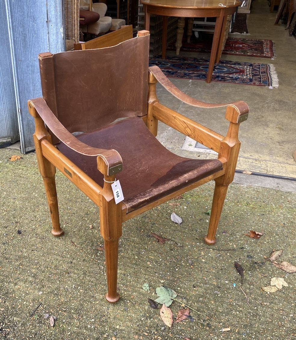 A mid century Italian 'Mufti' Michael D'Souza walnut and tan leather elbow chair, width 60cm, depth 54cm, height 84cm